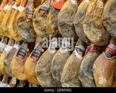 Santa Cruz de Tenerife, Spain - March 19th, 2022: Serrano ham legs for sale in a supermarket in Spain. Stock Photo