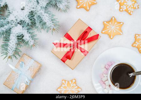 Christmas composition. Gift, fir tree branches, cup of coffee on snow background. Christmas, winter, new year concept. Flat lay, Stock Photo