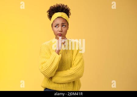 Unsure hesitant worried cute african-american girl face tough decision look up thoughtful make plan thinking how act right touch Stock Photo
