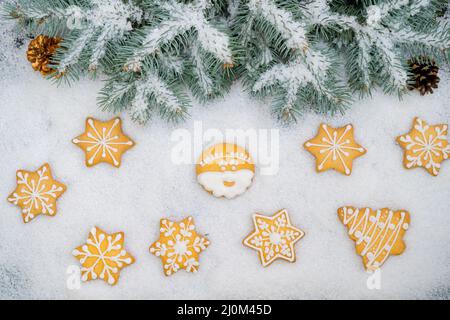 Pattern of gingerbread cookies in different shapes on a dark surface. Top view. Stock Photo