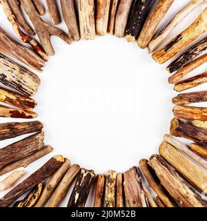 Background with a round frame of sea driftwood on a white background top view Stock Photo