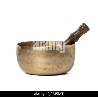 Copper singing bowl and wooden mallet isolated on white background. Musical instrument for meditation, relaxation, various medic Stock Photo