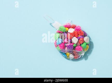 Multicolored decorative stones on a blue background, top view. decor for flowerpots Stock Photo