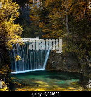 View of the Pisnica Waterfall near Kranjska Gora in the Julian Alps of Slovenia in late autumn Stock Photo