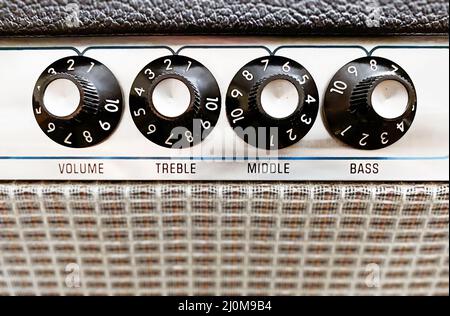 Close-up view of the knobs of an amplifier for adjusting the sound of stringed musical instruments Stock Photo
