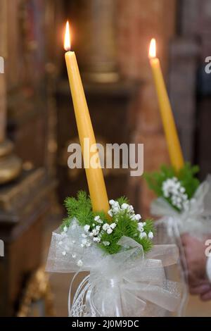 Selective focus shot of lighted candles inside the church Stock Photo