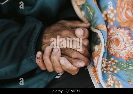 Homeless man holding his hands with blanket Stock Photo