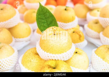 Stacks of apples packed in baskets at food market Stock Photo