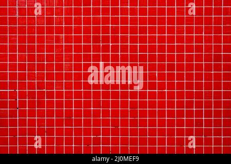 Background from a wall made of red mosaic tiles Stock Photo