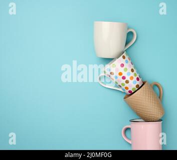 A stack of empty ceramic cup on a blue background Stock Photo