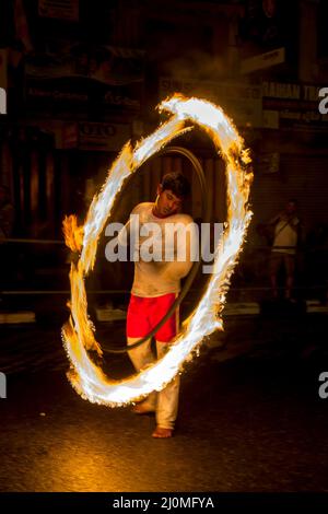 A Fire Ball Dancer performs along Colombo Street at Kandy in Sri Lanka during the Buddhist Esala Perahera (great procession). Stock Photo