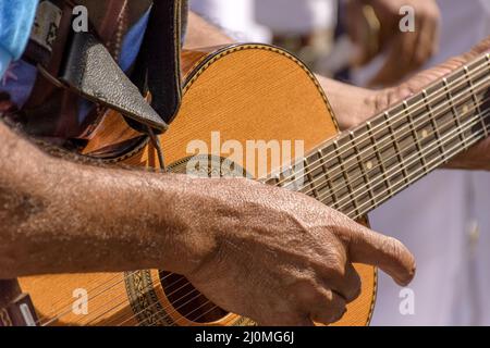 Detail of guitarist's hands and his acoustic guitar Stock Photo