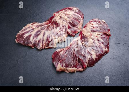 Raw wagyu spider beef steak offered as close-up on a black board with copy space Stock Photo