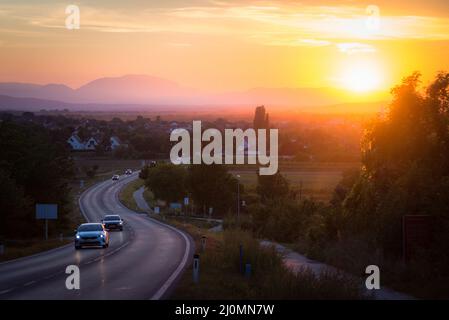 Traffic on asphalt road or highway route at sunset time Stock Photo