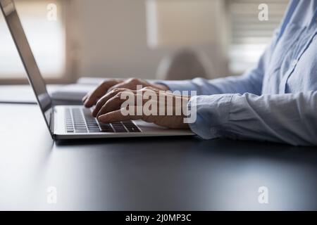 Closeup older female hands typing on modern laptop keyboard Stock Photo