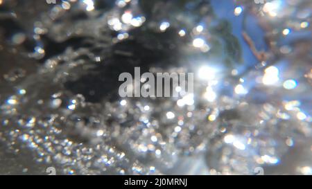 Abstract moving blurred background. Flowing water of mountain river below Stock Photo