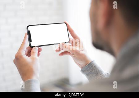 Close up man holding smartphone Stock Photo