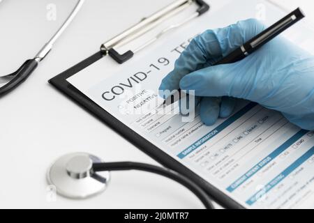 Close up doctor completing covid medical form