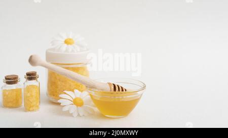 Arrangement with honey salts white background Stock Photo