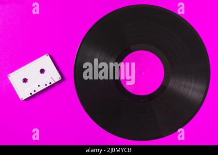 Audio white cassette tape vinyl record pink background Stock Photo