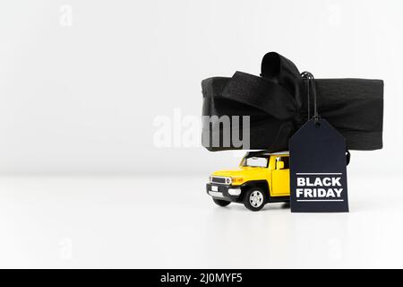 Black friday toy car carrying gift Stock Photo
