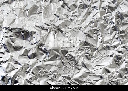Crumpled silver aluminium foil background Stock Photo