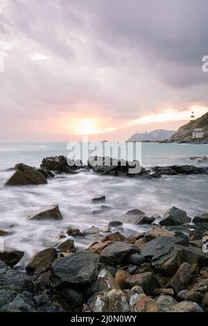 Crashing waves over rocks at Cape D'Aguilar Marine Reserve, Hong Kong. Stock Photo