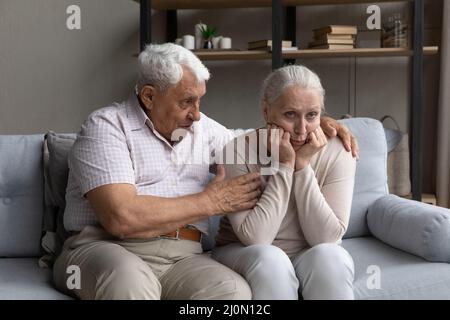 Older husband apologizes to his spouse after quarrel Stock Photo