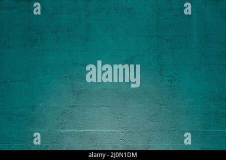 Close-up of plastered and painted blue green concrete wall with light effect. Abstract high resolution full frame textured background. Copy space. Stock Photo