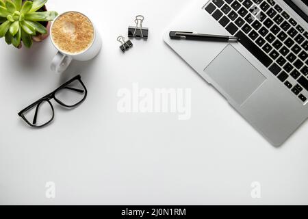 Flat lay desk with laptop glasses Stock Photo