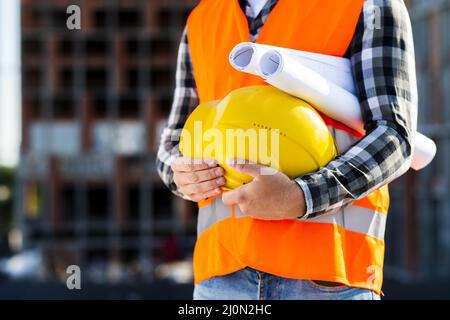 Close up construction engineer holding helmet Stock Photo