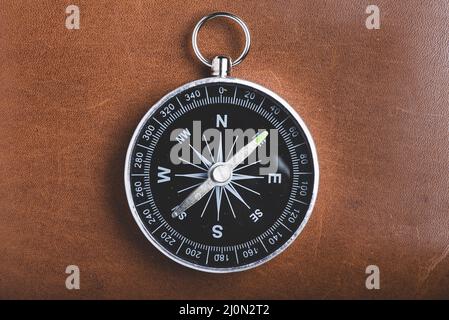 Close up of compass on wooden background Stock Photo