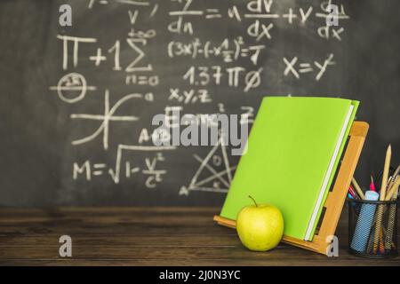 Book holder with book stationery near blackboard Stock Photo