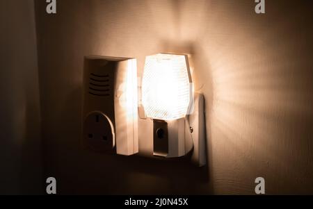 Close up of a night light plugged into a wall in a house Stock Photo