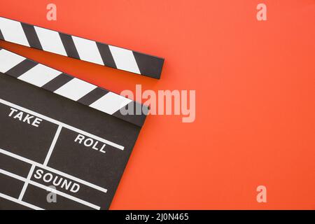 Clapperboard on red background with space Stock Photo