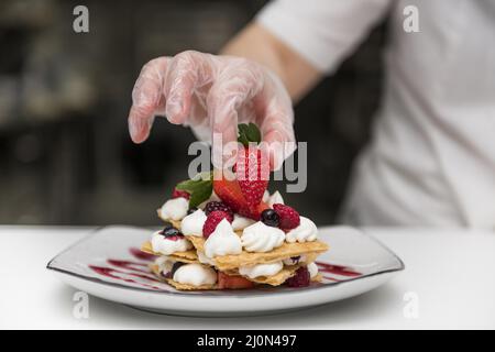 (1)chef putting strawberry dessert Stock Photo