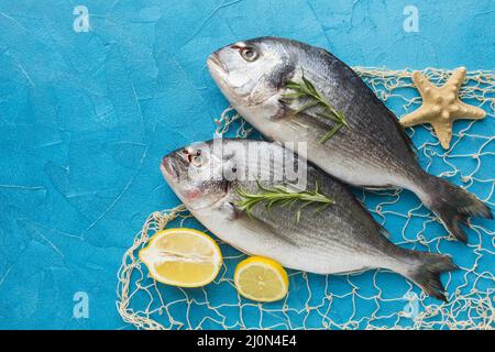 Fish arrangement with lemon top view Stock Photo