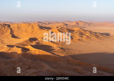 Sunrise from Ramlat Jadilah (Jadaylah), the highest sand dune in the world (455 m), situated in the Rub' al Khali (Empty Quarter) desert, Oman Stock Photo