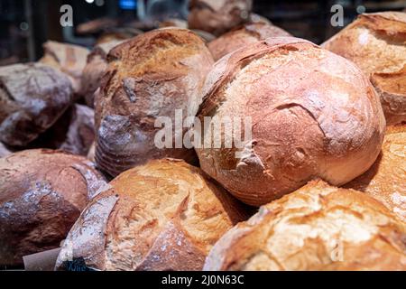 Large loaves of bread on the counter of a bakery. Stock Photo
