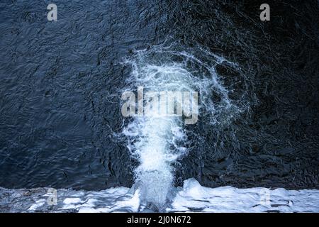 Natural waterfall, top view, water texture and foaming waves. Stock Photo