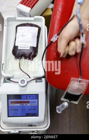 Blood transfer. A woman takes blood for analysis. Checking blood rheology using modern equipment. Stock Photo