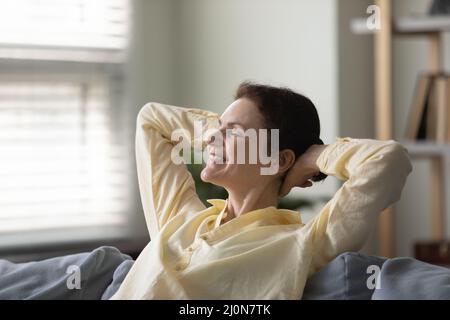 Happy middle aged woman taking deep breath of fresh air Stock Photo