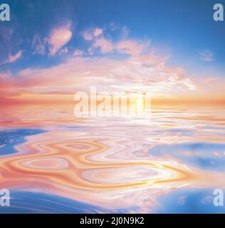 Soft pink and orange clouds reflected on calm water create a soothing, dreamlike seascape Stock Photo