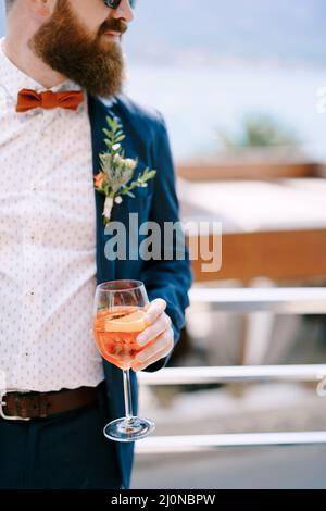 Bearded redhead groom with a glass in his hand Stock Photo