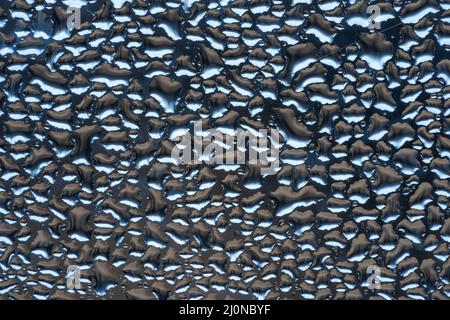 Macro close up of water droplets on glass created by water vapor Stock Photo