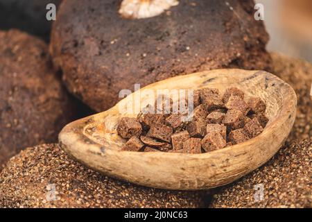Homemade black rye cereal bread with hemp seeds in a traditional street food market, close up Stock Photo