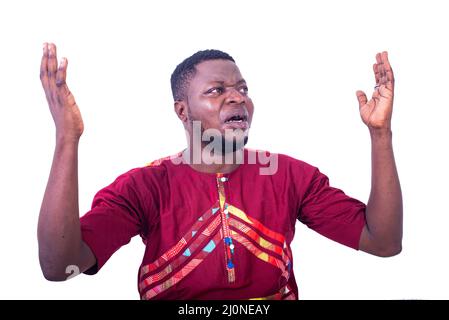 handsome young man in anger, wearing a magnificent shirt and spreading his hands. Stock Photo