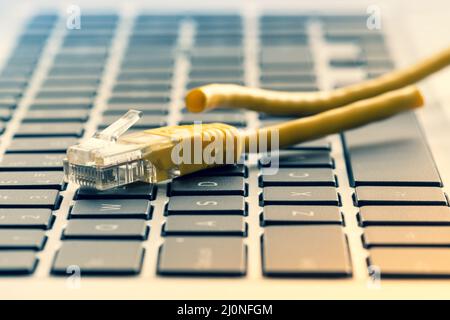 Keyboard with cut internet cable Stock Photo