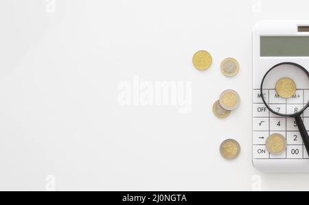 Magnifier calculator with copy space coins . High quality and resolution beautiful photo concept Stock Photo