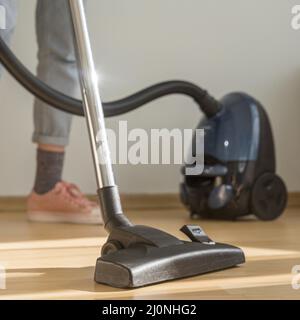 Woman cleaning room with vacuum cleaner. High quality and resolution beautiful photo concept Stock Photo